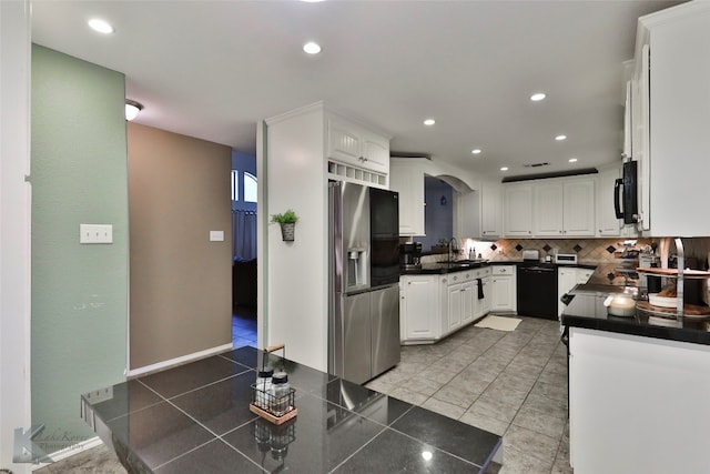 kitchen featuring decorative backsplash, sink, white cabinetry, and black appliances