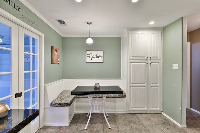 dining area with crown molding, breakfast area, and french doors