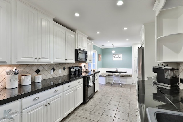 kitchen with white cabinets, light tile patterned floors, backsplash, and black appliances