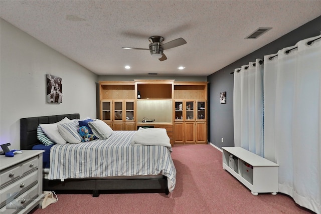 bedroom with carpet flooring, a textured ceiling, and ceiling fan