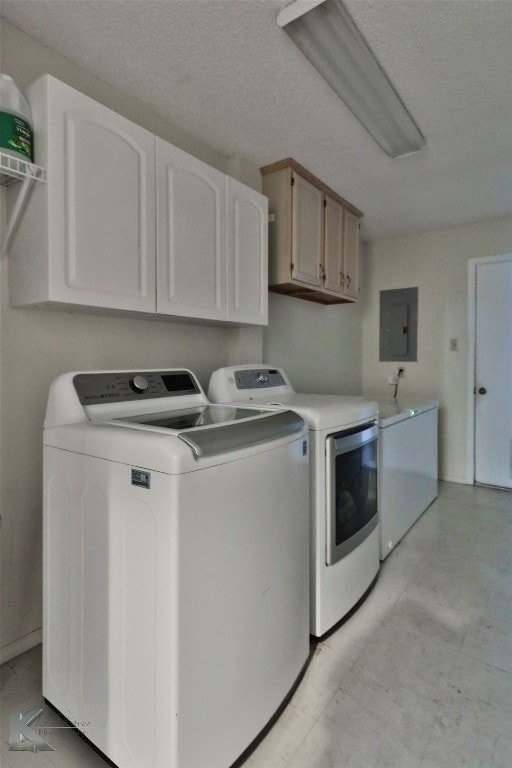 washroom with cabinets, separate washer and dryer, and electric panel