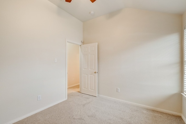 spare room featuring light carpet, high vaulted ceiling, and ceiling fan