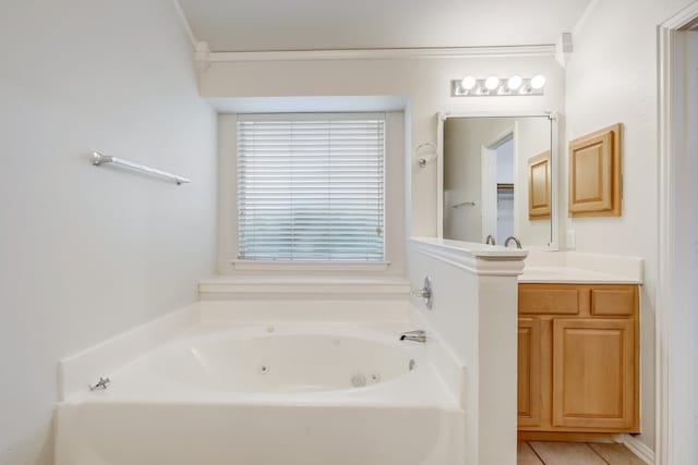 bathroom with tile floors, a bathtub, vanity, and crown molding