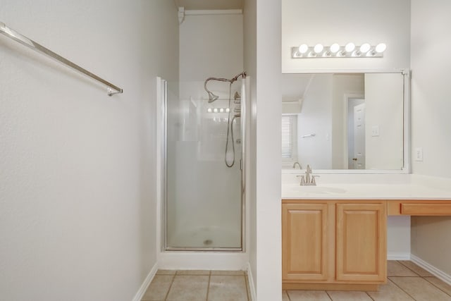 bathroom with an enclosed shower, vanity with extensive cabinet space, and tile flooring