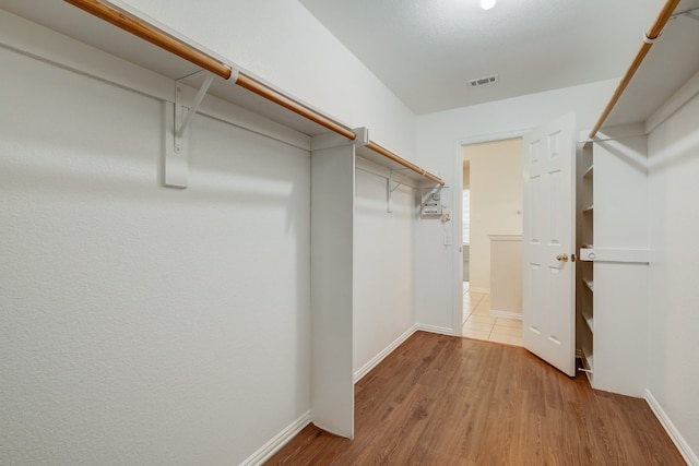 spacious closet featuring light hardwood / wood-style flooring