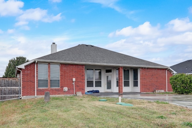 view of front facade featuring a front yard and a patio area