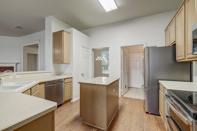 kitchen featuring a notable chandelier, light brown cabinets, sink, light tile floors, and stainless steel dishwasher