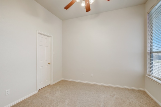 empty room featuring light carpet and ceiling fan