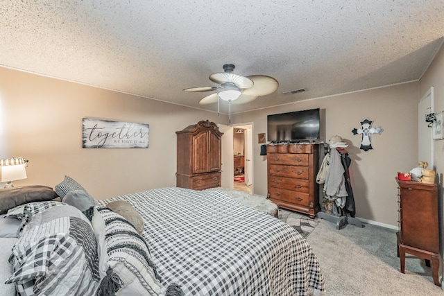 bedroom with light carpet, ceiling fan, and a textured ceiling