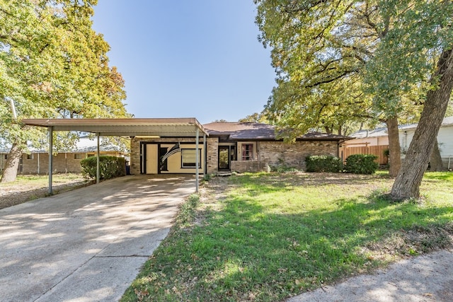 ranch-style house featuring a front yard and a carport