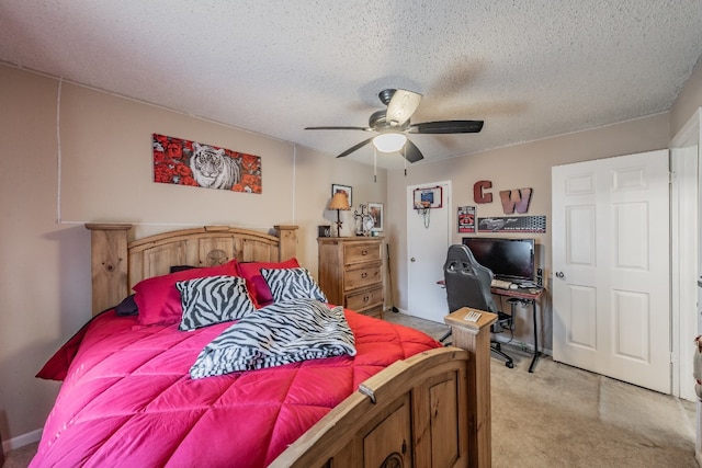 bedroom with light colored carpet, ceiling fan, and a textured ceiling