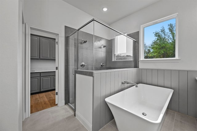 bathroom with tile patterned flooring and plus walk in shower