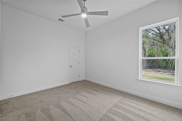 carpeted spare room with ceiling fan