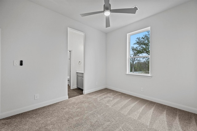 unfurnished room featuring dark carpet and ceiling fan