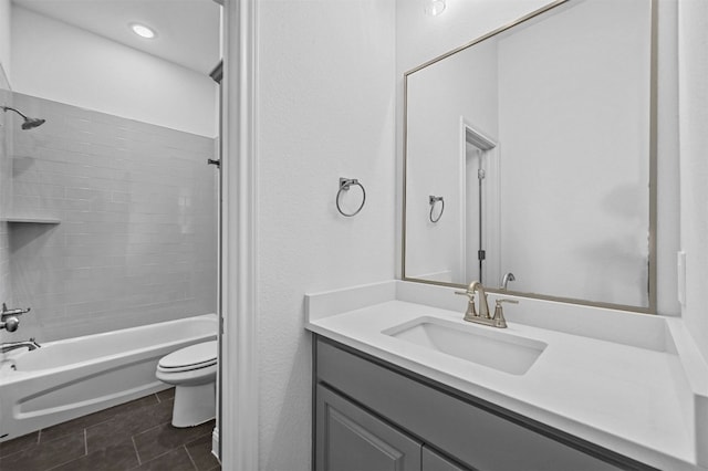 full bathroom with tile patterned floors, toilet, vanity, and tiled shower / bath