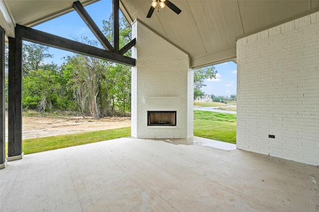 view of patio / terrace featuring ceiling fan and an outdoor brick fireplace