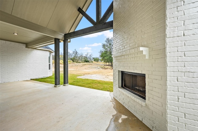 view of patio / terrace featuring an outdoor brick fireplace