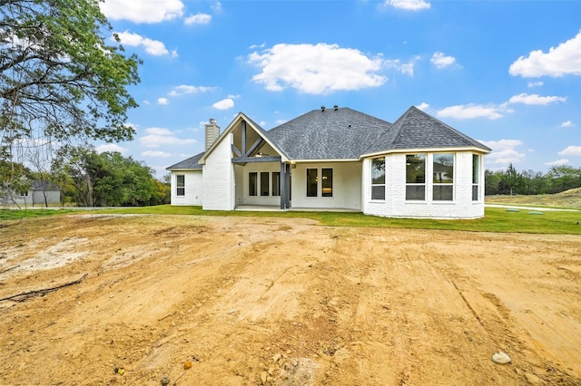 back of house with a yard