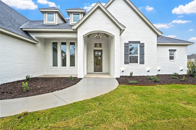 property entrance with a lawn