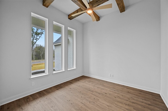 spare room featuring vaulted ceiling with beams, ceiling fan, and light hardwood / wood-style flooring