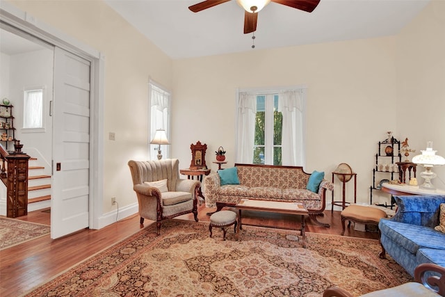 living room with ceiling fan and light hardwood / wood-style flooring