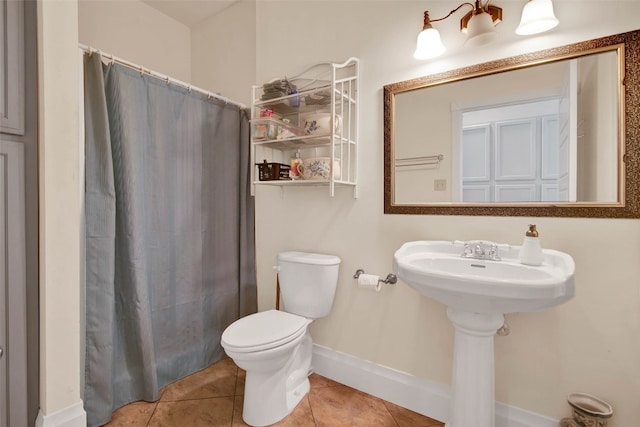 bathroom featuring tile floors and toilet