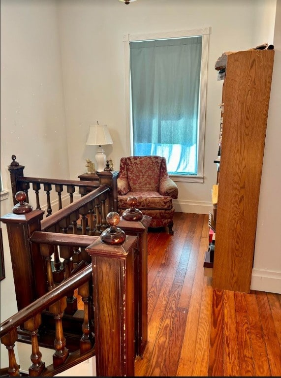 sitting room with dark wood-type flooring