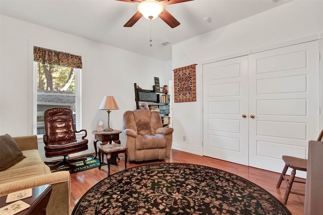 sitting room with light hardwood / wood-style flooring and ceiling fan