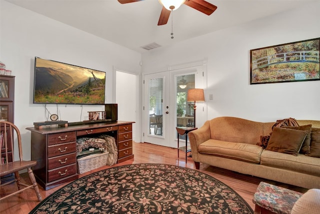 living room with ceiling fan, light hardwood / wood-style flooring, and french doors