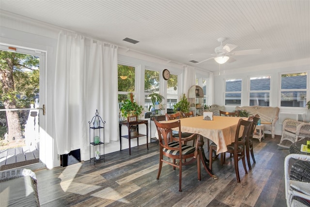 dining space with ceiling fan, dark wood-type flooring, and a healthy amount of sunlight