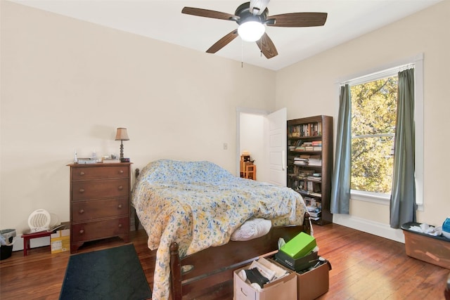 bedroom featuring ceiling fan and dark hardwood / wood-style floors