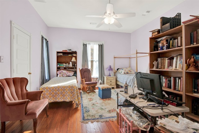 bedroom with ceiling fan and dark hardwood / wood-style floors