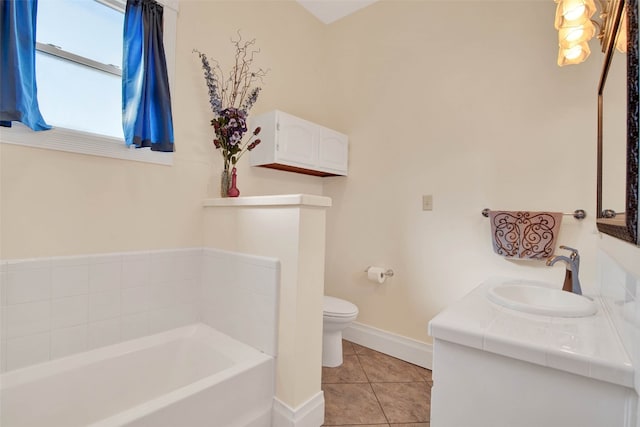 bathroom featuring vanity, tile floors, a bathtub, and toilet