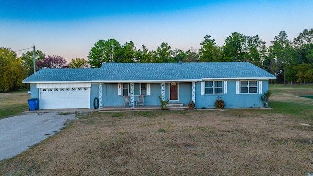 single story home with a lawn and a garage