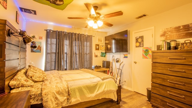 bedroom with ceiling fan and light wood-type flooring