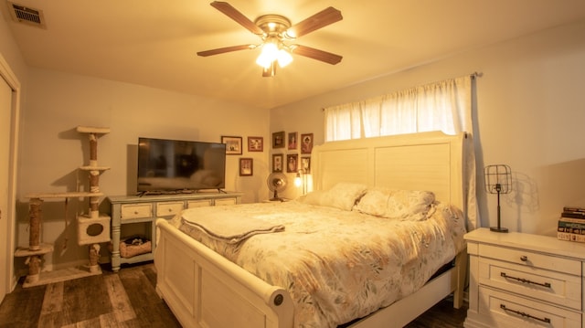 bedroom featuring ceiling fan and dark hardwood / wood-style floors