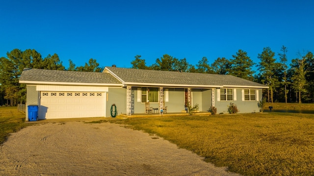 ranch-style house featuring a front yard and a garage