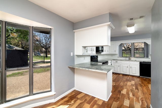 kitchen with white cabinetry, light hardwood / wood-style floors, and black appliances