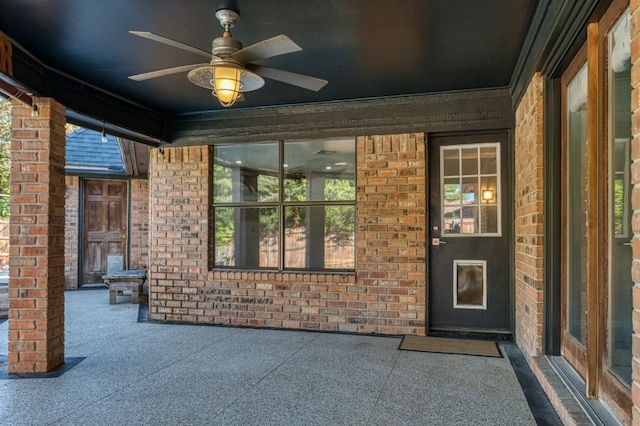 entrance to property featuring a patio area and ceiling fan