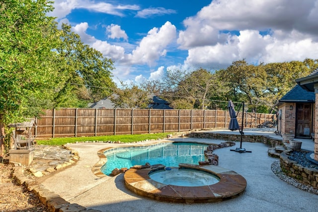 view of swimming pool featuring a patio and an in ground hot tub