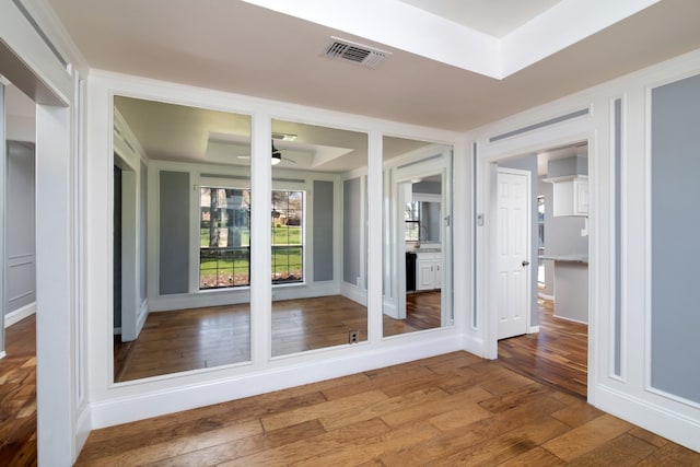 interior space with dark hardwood / wood-style floors and ceiling fan