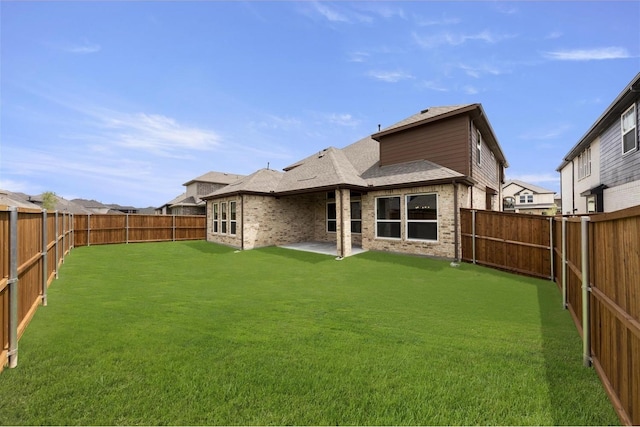 rear view of house featuring a patio and a lawn