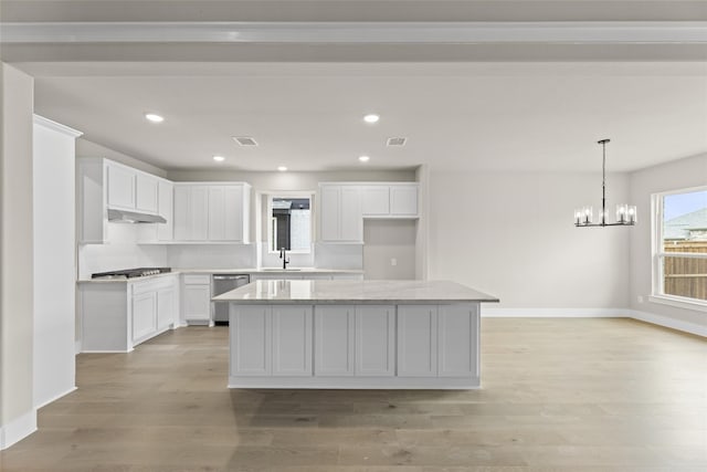 kitchen featuring a kitchen island, appliances with stainless steel finishes, white cabinetry, sink, and light hardwood / wood-style flooring