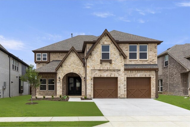 view of front facade featuring a garage and a front yard