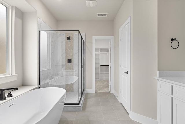 bathroom featuring vanity, shower with separate bathtub, and tile patterned floors