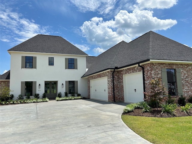 view of front of property featuring a garage and french doors