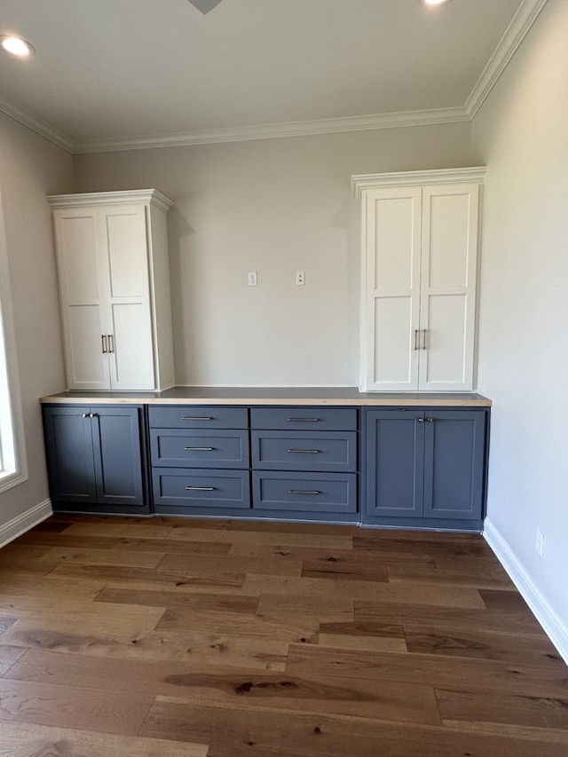 bar with baseboards, wood finished floors, and ornamental molding