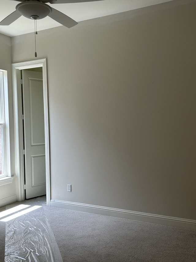 unfurnished bedroom with baseboards and carpet