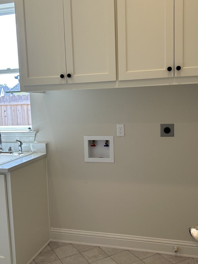 laundry area featuring baseboards, washer hookup, light tile patterned floors, cabinet space, and hookup for an electric dryer