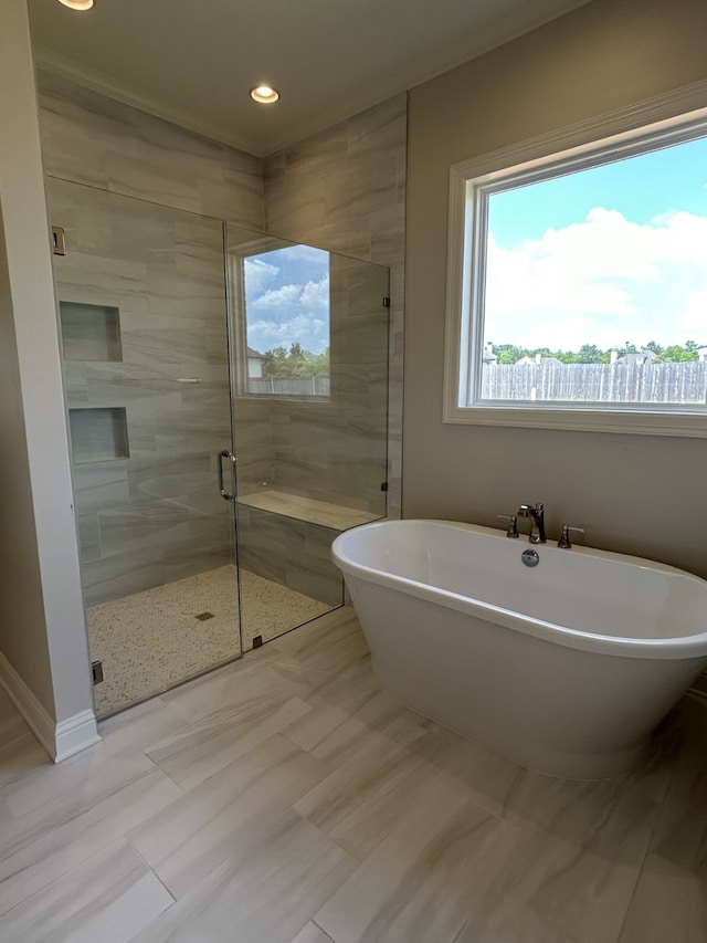 bathroom with a soaking tub, recessed lighting, and a shower stall